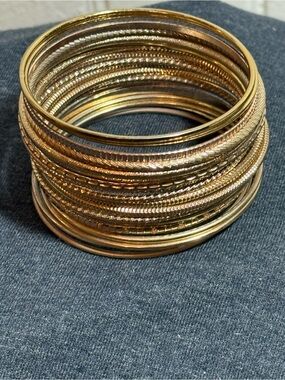 Gold-Tone Bangle Bracelets. 20 in total.